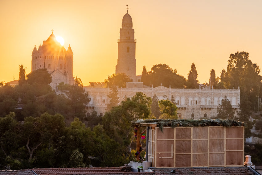 A rooftop sukkah in Jerusalem at sunset, with iconic skyline views during the Sukkot 2026 holiday observance in Israel.